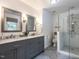 Bathroom showcasing a dual vanity with marble countertop and glass enclosed shower at 8805 Stage Ford Rd, Raleigh, NC 27615