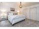 Bright bedroom featuring neutral decor, chandelier, and closet space at 8805 Stage Ford Rd, Raleigh, NC 27615