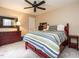 Bedroom with colorful striped bedding, red accents, and carpeted floor at 8805 Stage Ford Rd, Raleigh, NC 27615