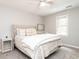 Bright bedroom with large window, upholstered headboard, and patterned bedding at 8805 Stage Ford Rd, Raleigh, NC 27615