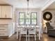 Bright dining room with white table set, black frame windows and hardwood floors at 8805 Stage Ford Rd, Raleigh, NC 27615