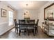 Classic dining room with a dark wood table, six chairs, and elegant lighting at 8805 Stage Ford Rd, Raleigh, NC 27615
