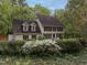 Charming two-story home boasts a lush front yard and classic architectural details at 8805 Stage Ford Rd, Raleigh, NC 27615