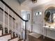 Bright foyer with hardwood floors, a staircase, and a charming entryway table at 8805 Stage Ford Rd, Raleigh, NC 27615