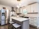 Modern kitchen with stainless steel appliances, white cabinetry, and central island at 8805 Stage Ford Rd, Raleigh, NC 27615