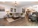 Cozy living room with hardwood floors, comfortable seating, and an open flow to the kitchen at 8805 Stage Ford Rd, Raleigh, NC 27615