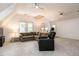 Spacious living room with sloped ceilings, large sectional sofa, and windows at 8805 Stage Ford Rd, Raleigh, NC 27615