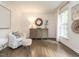 Light-filled living room with hardwood floors, neutral decor, and large windows at 8805 Stage Ford Rd, Raleigh, NC 27615