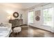 Inviting living room with hardwood floors, neutral decor, and natural light from large windows at 8805 Stage Ford Rd, Raleigh, NC 27615
