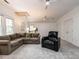 Spacious living room with sloped ceilings, large sectional sofa, and windows at 8805 Stage Ford Rd, Raleigh, NC 27615