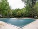 A community pool covered with a green tarp sits among lush green trees at 8805 Stage Ford Rd, Raleigh, NC 27615