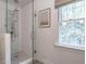 Glass enclosed shower with white subway tile and mosaic tile accents at 8805 Stage Ford Rd, Raleigh, NC 27615