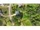 An aerial view shows a home with a driveway and mature landscaping within a lush, green neighborhood at 9016 New Century Rd, Wake Forest, NC 27587