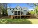 View of the home's backyard featuring a screened-in porch and wooden deck at 9016 New Century Rd, Wake Forest, NC 27587