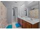 Bathroom featuring a double sink vanity, a large mirror, and a shower with a coral-themed shower curtain at 9016 New Century Rd, Wake Forest, NC 27587