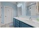 Bathroom featuring a dual sink vanity with blue cabinets and a large mirror offering ample space and storage at 9016 New Century Rd, Wake Forest, NC 27587