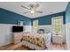 Bedroom featuring a large decorative bed, two windows, and a dresser with a television on top at 9016 New Century Rd, Wake Forest, NC 27587