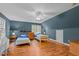 Comfortable bedroom featuring two beds, laminate floors, and a bright window with natural light at 9016 New Century Rd, Wake Forest, NC 27587