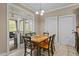Sunny dining area with a wooden table and chairs, with access to an outdoor porch area at 9016 New Century Rd, Wake Forest, NC 27587