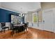 Elegant dining room featuring hardwood floors, a chandelier, and a display case adding a touch of sophistication at 9016 New Century Rd, Wake Forest, NC 27587