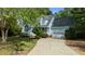 Charming blue two-story home with manicured lawn and a two-car garage with ample driveway parking at 9016 New Century Rd, Wake Forest, NC 27587