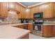 Kitchen features light countertops, stainless steel appliances and warm wood cabinetry at 9016 New Century Rd, Wake Forest, NC 27587