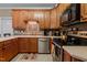 Practical kitchen layout featuring light countertops, stainless steel appliances and cozy lighting at 9016 New Century Rd, Wake Forest, NC 27587