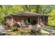 Brick porch featuring rocking chairs, ATV, wrought iron, and outdoor seating area at 906 Circle Dr, Creedmoor, NC 27522