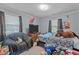 A playful bedroom with a cozy chair and plenty of space, decorated with colorful wall art and stuffed animals at 906 Circle Dr, Creedmoor, NC 27522
