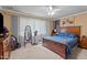Spacious bedroom showcasing a large window and a comfortable bed, complemented by a ceiling fan for climate control at 906 Circle Dr, Creedmoor, NC 27522