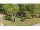 Brick home with a large front yard partially shaded by trees, offering a blend of comfort and natural beauty at 906 Circle Dr, Creedmoor, NC 27522
