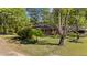 Brick home with inviting front yard surrounded by mature trees for shade and privacy at 906 Circle Dr, Creedmoor, NC 27522