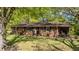 Charming brick home with a well-maintained lawn and mature trees, offering a serene and inviting curb appeal at 906 Circle Dr, Creedmoor, NC 27522