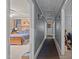 A long hallway with neutral walls connecting various rooms, offering a glimpse into a neatly kept bedroom at 906 Circle Dr, Creedmoor, NC 27522