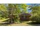 Quaint home exterior with brick facade, nestled among lush greenery for a private, secluded feel at 906 Circle Dr, Creedmoor, NC 27522