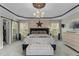 A primary bedroom featuring an accent wall, ample natural light, and stylish decor at 9212 Linslade Way, Wake Forest, NC 27587