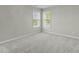 Spacious bedroom with plush carpet and two windows offering ample natural light at 9212 Linslade Way, Wake Forest, NC 27587