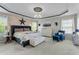 A primary bedroom featuring an accent wall, ample natural light, and stylish decor at 9212 Linslade Way, Wake Forest, NC 27587