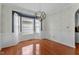 Bright dining room with hardwood floors, wainscoting, and a modern chandelier fixture at 9212 Linslade Way, Wake Forest, NC 27587