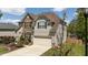 Lovely two-story home with stone and vinyl siding, two-car garage, and well-maintained landscaping at 9212 Linslade Way, Wake Forest, NC 27587