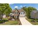 Beautiful two-story home with manicured lawn, stone accents, lush landscaping, and a two-car garage at 9212 Linslade Way, Wake Forest, NC 27587
