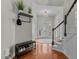 The bright foyer features a staircase, hardwood floors, decorative lighting, and storage at 9212 Linslade Way, Wake Forest, NC 27587