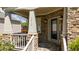Inviting front porch featuring stone columns, decorative lighting, and a welcoming entrance at 9212 Linslade Way, Wake Forest, NC 27587