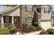 Charming home exterior with stone accents, a covered porch, and lush landscaping at 9212 Linslade Way, Wake Forest, NC 27587