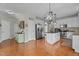Spacious kitchen with hardwood floors, a stainless-steel refrigerator, and a large white island at 9212 Linslade Way, Wake Forest, NC 27587