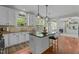 An open concept kitchen offers a black island, granite countertops, and lots of natural light at 9212 Linslade Way, Wake Forest, NC 27587