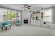 A cozy living room features a brick fireplace, custom built-ins, a ceiling fan and two chairs at 9212 Linslade Way, Wake Forest, NC 27587