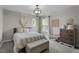 Well-decorated bedroom with stylish furnishings, a statement light fixture, and an accent wall hanging at 9212 Linslade Way, Wake Forest, NC 27587