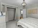 Bedroom featuring closet with curtains, an open ensuite door, and a decorative light fixture at 9212 Linslade Way, Wake Forest, NC 27587