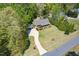 Aerial view of home showcasing lush greenery, long driveway, and well-manicured lawn at 936 Elbridge Dr, Raleigh, NC 27603